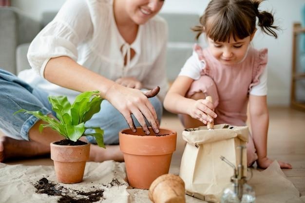 kid potting plant at home as a hobby