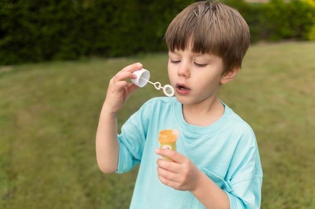 boy playing with bubble soap