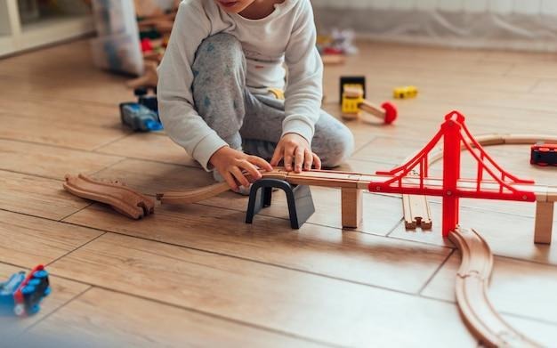 kid playing with toy train