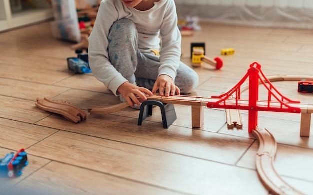 kid playing with toy train