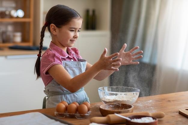 side view girl cooking at home